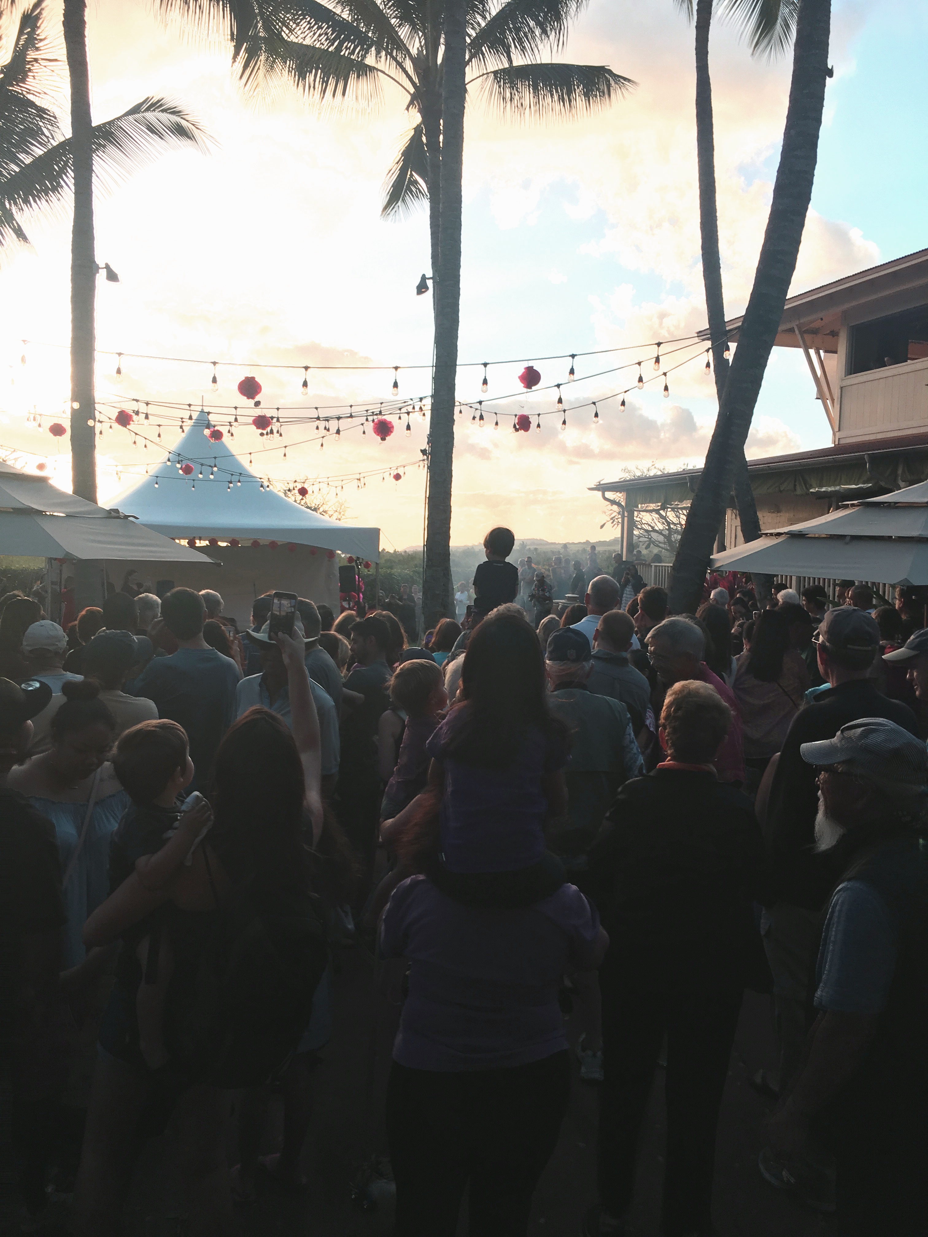 A large group gathers outside in Kauai at a Chinese New Year celebration