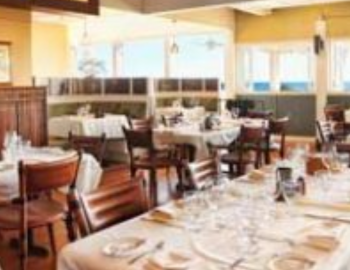 a long table set at an empty poipu restaurant